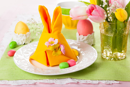 Festive table setting with Easter bunny napkinの写真素材