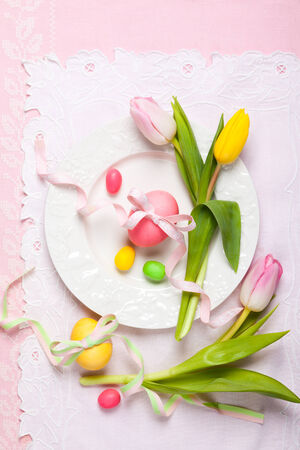Easter table setting with tulips and easter eggsの写真素材