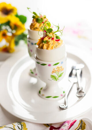 Stuffed eggs filled with cucumber,radish and green pea for Easterの写真素材
