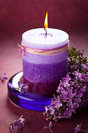 Aromatic candle with violet lilacの写真素材