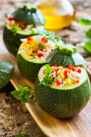 Round zucchini stuffed with vegetables and riceの写真素材