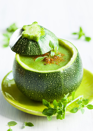 Zucchini cream soup served in a round zucchiniの写真素材