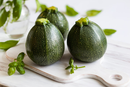 Round zucchinis on the wooden boardの写真素材
