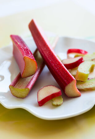 fresh stems of rhubarb on the plateの写真素材