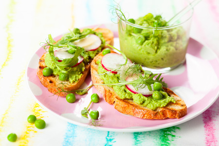 Crostini with pea puree,radish,rocket and cheeseの写真素材