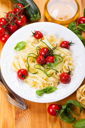 Tagliatelle with cherry tomatoes and zucchiniの写真素材