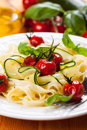 Tagliatelle with cherry tomatoes and zucchiniの写真素材