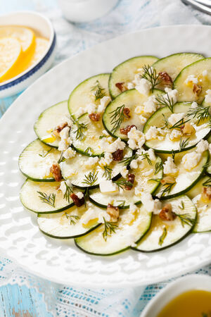 Zucchini Carpaccio with feta,walnut and dillの写真素材