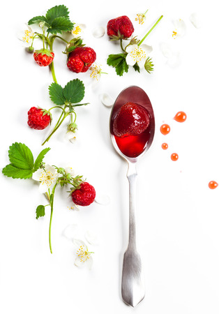 Strawberry jam in spoon and fresh berries on white backgroundの写真素材
