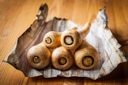 Fresh parsnip on wooden tableの写真素材
