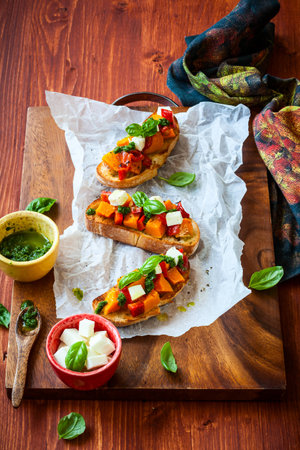 Bruschetta with roasted pumpkin, red pepper,pesto and cheeseの写真素材