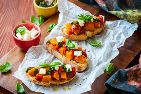 Bruschetta with roasted pumpkin, red pepper,pesto and cheeseの写真素材