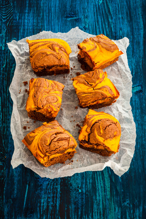 Pumpkin swirl brownies on blue wooden backgroundの写真素材