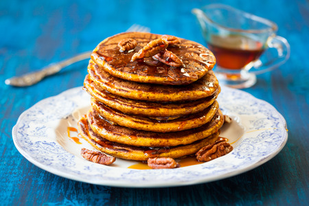 Spiced Pumpkin pancakes with maple syrup and pecanの写真素材