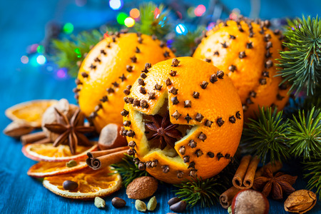 Oranges pierced with cloves,Christmas spices and nutsの写真素材