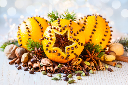 Oranges pierced with cloves,Christmas spices and nutsの写真素材