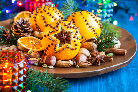 Oranges pierced with cloves,Christmas spices and nutsの写真素材