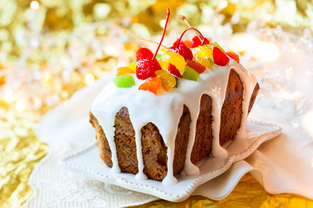 Christmas fruitcake with sugar icing and candied fruitsの写真素材