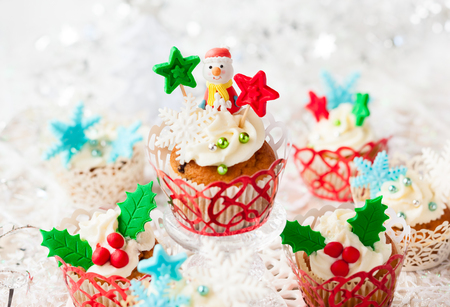 Festive Christmas cupcakes with vanilla frosting and sugar decorationの写真素材