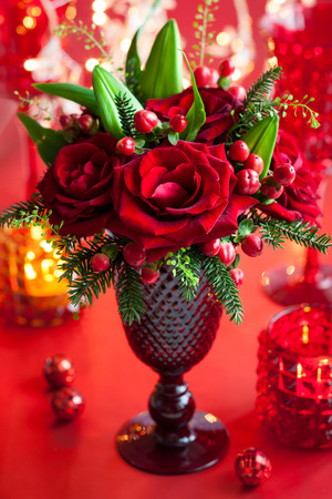 Christmas table decoration with flowers and candlesの写真素材