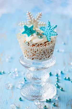 Festive Christmas cupcakes decorated with sugar snowflakesの写真素材