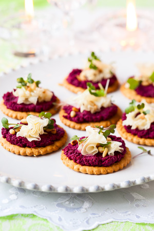 Festive appetizer: crackers with beet pesto and cheeseの写真素材