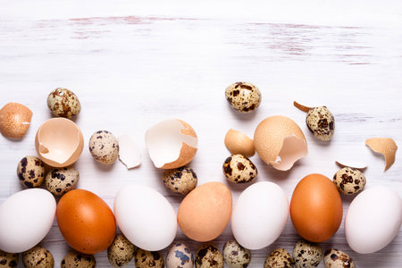 Different types of eggs on a white wooden backgroundの写真素材