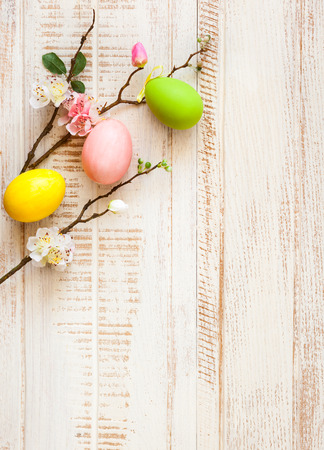 Colorful easter eggs and branch with spring flowersの写真素材