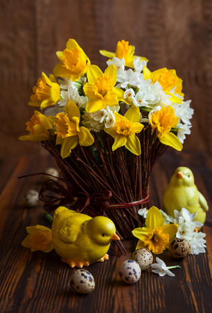 Easter table decoration with fresh daffodils,chick and eggsの写真素材