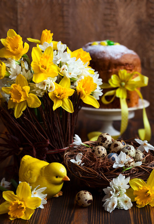 Easter table decoration with fresh daffodils,chick and eggsの写真素材