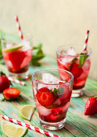 Refreshing summer drink with Strawberry in jug and glasses on the vintage wooden tableの写真素材