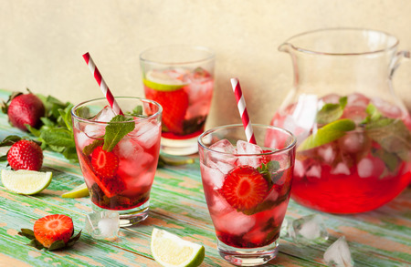Refreshing summer drink with Strawberry in jug and glasses on the vintage wooden tableの写真素材