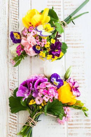 Beautiful bunch of flowers on the wooden tableの写真素材