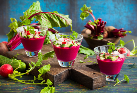 Beetroot gazpacho soup with cucumber and radish in  glassesの写真素材