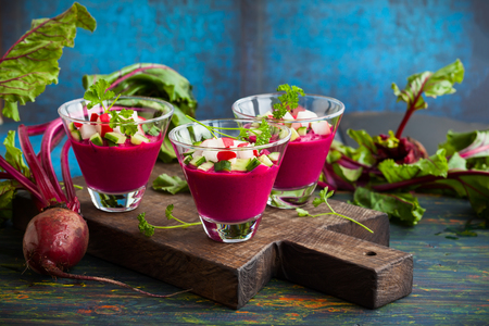 Beetroot gazpacho soup with cucumber and radish in  glassesの写真素材