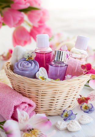Spa bath toiletries set in basket with fresh flowersの写真素材