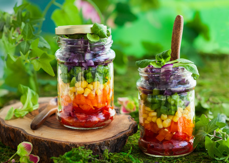 Vegetarian Rainbow salad in a glass jar for summer picnicの写真素材