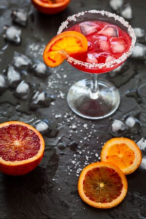 Blood Orange Margarita in glass with salted rimの写真素材