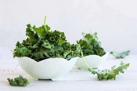 Fresh green kale leaves in  bowlの写真素材