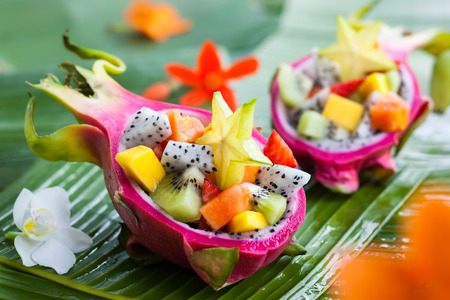 Exotic fruit salad served in half a dragon fruitの写真素材