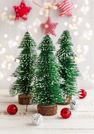 Three decorative Christmas tree on the white wooden backgroundの写真素材