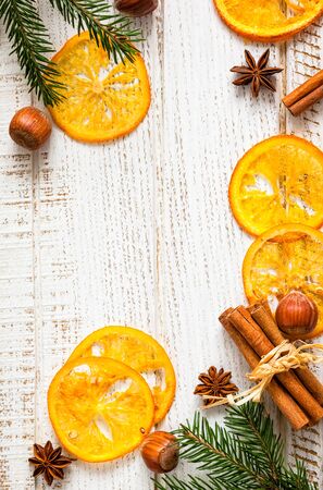 Christmas decoration with fir branches,star anise,cinnamon stick,nuts and slices of dried orangesの写真素材