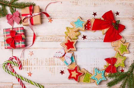 Christmas cookies, gift boxes and candy canes on wooden backgroundの写真素材
