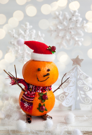 Happy snowman made out of tangerines,clove and winter berriesの写真素材
