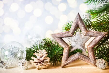 Christmas background with decorative star, fir branches and pine conesの写真素材