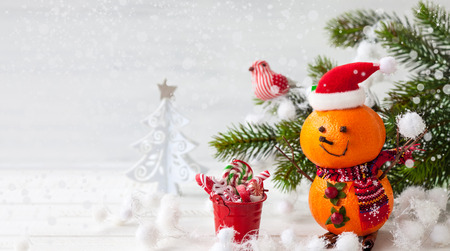 Happy snowman made out of tangerines,clove and winter berriesの写真素材