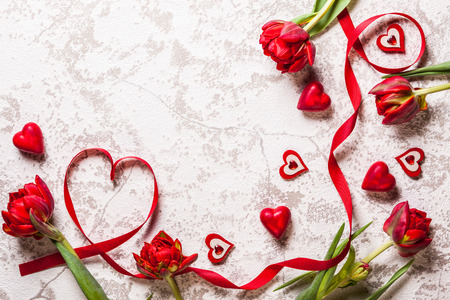 Valentines Day background with hearts and red tulipsの写真素材
