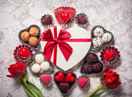 Gourmet chocolates and red tulips for Valentine's Dayの写真素材