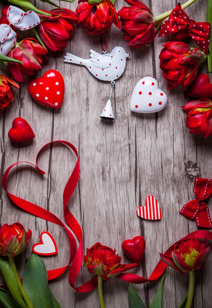 Valentines Day background with chocolates, hearts and red tulipsの写真素材