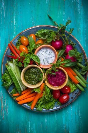 Veggie crudite platter with three different dipsの写真素材